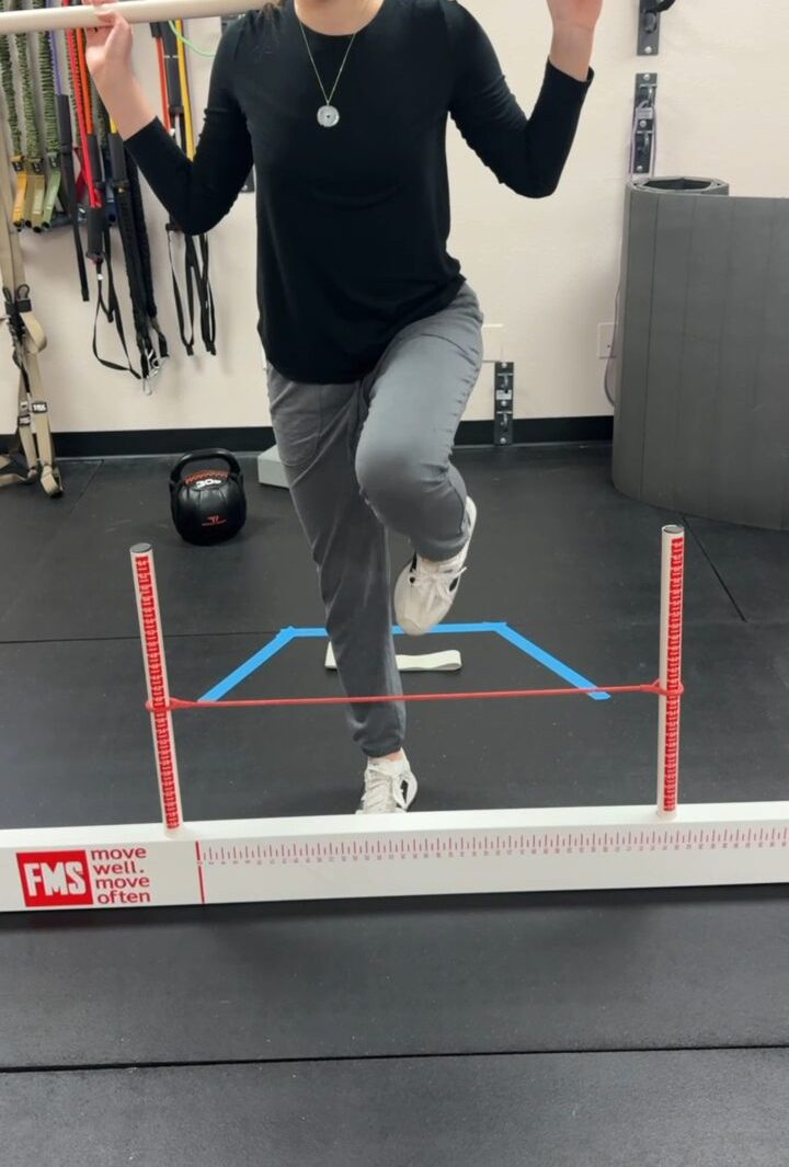 Functional Movement Screen hurdle step test on the FMS kit at Taylor Made Integrative Therapy in Fort Worth