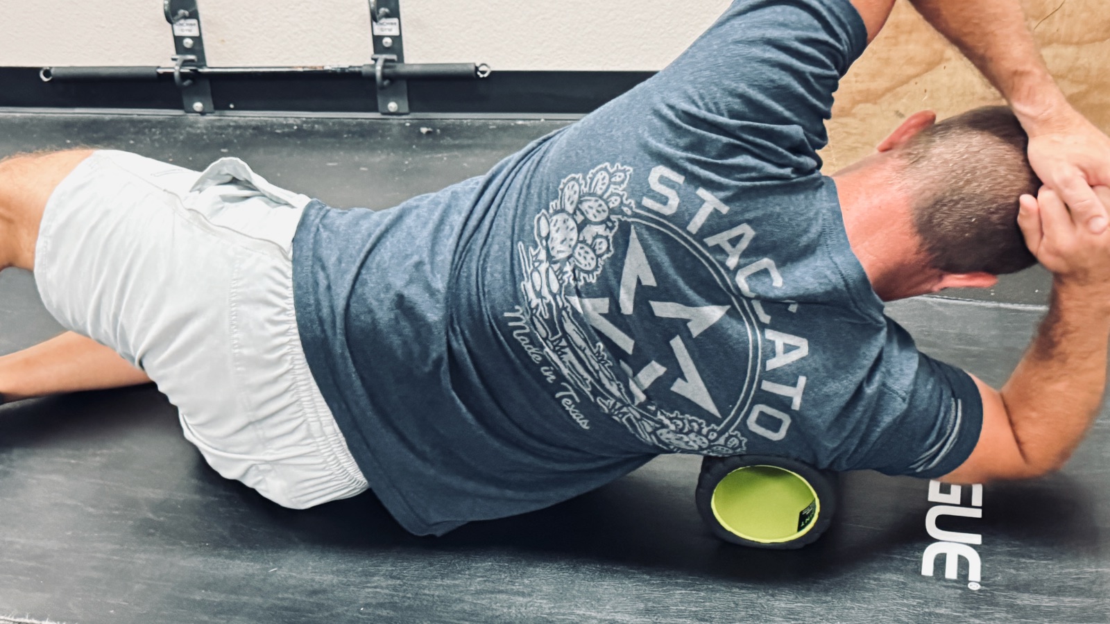 Athlete foam rolling the lats for recovery at a Fort Worth sports chiropractic clinic