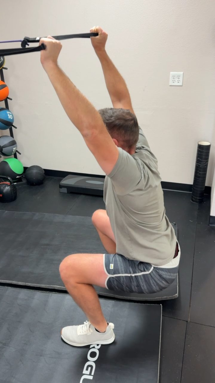Banded overhead squat strength and stability exercise at Taylor Made Integrative Therapy in Fort Worth