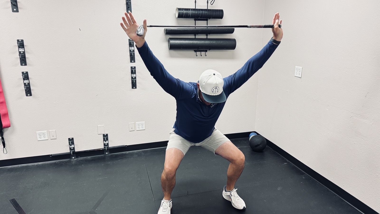 Dr. Jeremy Taylor demonstrating the overhead squat mobility screen at Taylor Made Integrative Therapy in Fort Worth