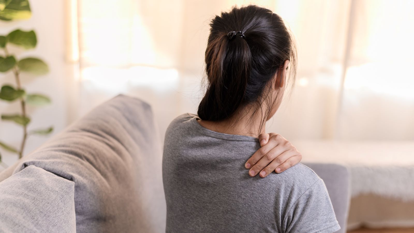 Active adult holding their neck after activity — why chronic pain keeps coming back
